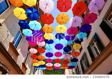 Colorful umbrellas lined up on the ceiling in Interlaken - a photogenic city walk Colorful umbrellas lined up on the ceiling in Interlaken - a photogenic city walk 130884370