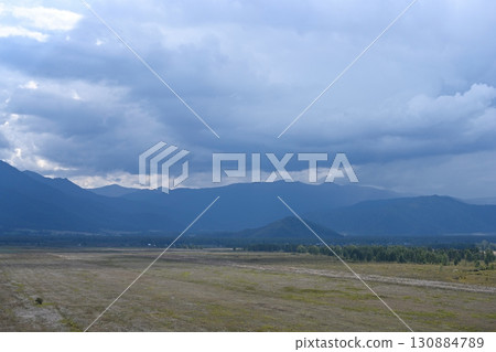Thunderclouds floating over the valley and mountains 130884789