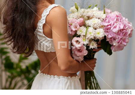 female hands holding bouquet flowers. Gift on the 8 march or valentines day. pink hydrangea female hands holding bouquet flowers. Gift on the 8 march or valentines day. pink hydrangea 130885041