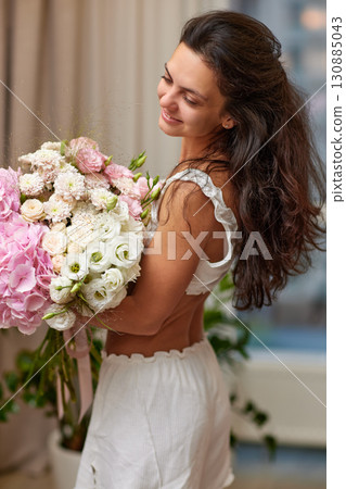 female hands holding bouquet flowers. Gift on the 8 march or valentines day. pink hydrangea 130885043