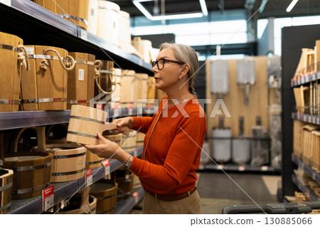 Shopping for decorative wooden storage baskets in a home goods store during the afternoon 130885066