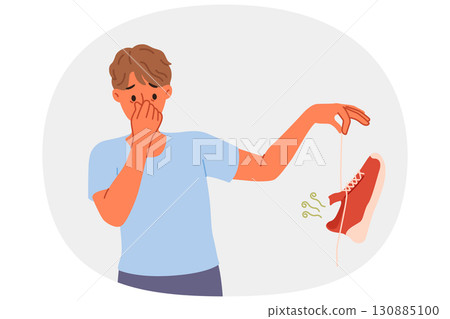 Man suffers from onychomycosis and stinky feet, covers nose with hands and holds stinky shoe 130885100