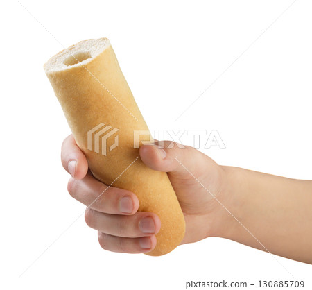 Hot dog bun in male hand on a white background. Isolated Hot dog bun in male hand on a white background. Isolated 130885709