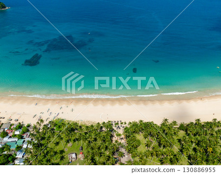 Top view of coconut trees in Nacpan Beach. Sea waves on sands. El Nido, Philippines. Top view of coconut trees in Nacpan Beach. Sea waves on sands. El Nido, Philippines. 130886955