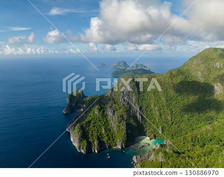 Cadlao Lagoon with boat and blue sea. Blue sky and clouds. El Nido, Philippines. Cadlao Lagoon with boat and blue sea. Blue sky and clouds. El Nido, Philippines. 130886970