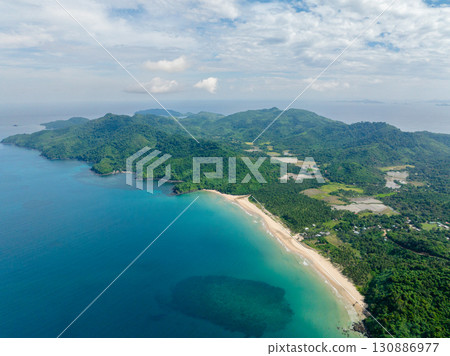 Sandy beach with inshore waves. Dagmay Beach. Blue sky and clouds. El Nido, Philippines. Sandy beach with inshore waves. Dagmay Beach. Blue sky and clouds. El Nido, Philippines. 130886977
