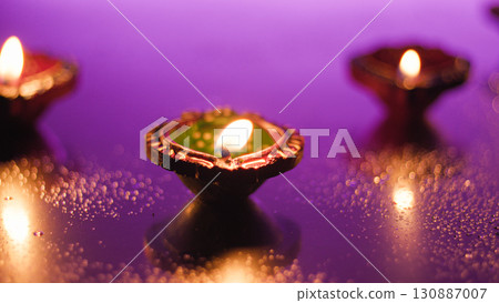 Colorful Diwali diyas lighting festive atmosphere Colorful Diwali diyas lighting festive atmosphere 130887007