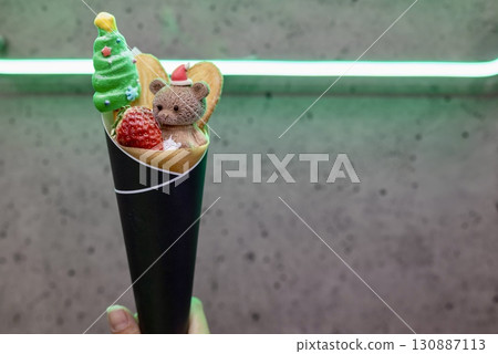 Christmas crepes featuring a bear in a Santa hat and a tree 130887113