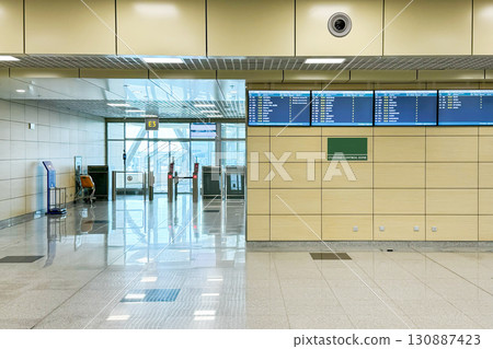 Brightly lit airport terminal with spacious area with gleaming tiled floors and clean, modern architecture, suggests an efficient and serene start to one's journey, emphasizing comfort in transit Brightly lit airport terminal with spacious area with gleaming tiled floors and clean, modern architecture, suggests an efficient and serene start to one's journey, emphasizing comfort in transit 130887423