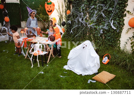 Children celebrating Halloween in costumes in the garden Children celebrating Halloween in costumes in the garden 130887711