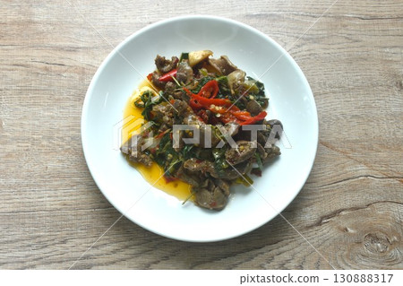 spicy chili stir-fried chicken gizzard and liver couple heartwith basil leaf on plate spicy chili stir-fried chicken gizzard and liver couple heartwith basil leaf on plate 130888317