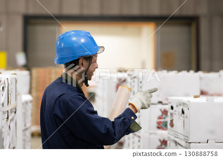 A man working in a refrigerated warehouse A man working in a refrigerated warehouse 130888758
