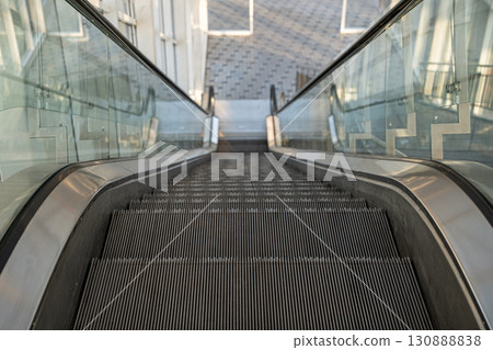 Empty escalator in modern building Empty escalator in modern building 130888838