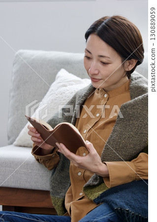 A woman reading a book A woman reading a book 130889059