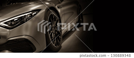 Front view of LED headlights sport car on black background toned in sepia 130889348