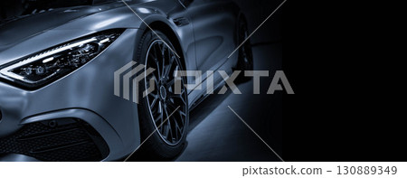 Front view of LED headlights sport car on black background is color blue tone  130889349