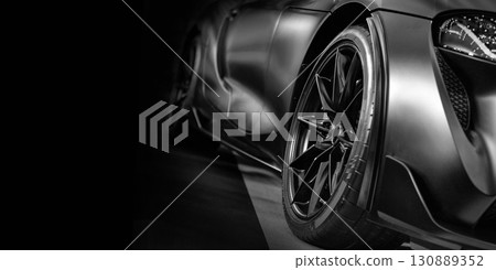 Front view of LED headlights sport car on black background 130889352