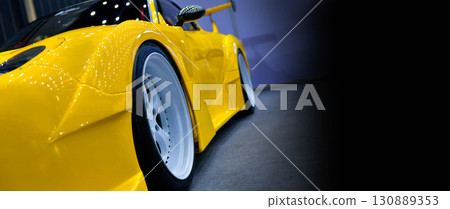 Front headlights of yellow modify car on black background, copy space Front headlights of yellow modify car on black background, copy space 130889353