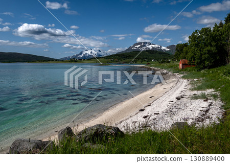 White Sand Beach And Snowy Mountains At The Fjord Cost Of Lofoten Islands In Norway 130889400