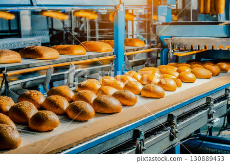 Automated production line conveyor belt oven bakery to freshly baked bread Generation AI 130889453