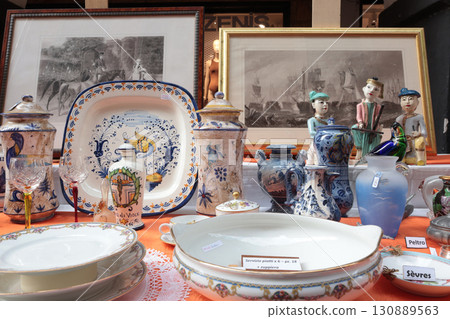 Chiaveri, Italy - September 13, 2025. Flea antique market in Europe, Italy. Old vintage items. Dishes on table in town. Retro objects for design. Chiaveri, Italy - September 13, 2025. Flea antique market in Europe, Italy. Old vintage items. Dishes on table in town. Retro objects for design. 130889563