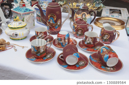 Chiaveri, Italy - September 13, 2025. Flea antique market in Europe, Italy. Old vintage items. Dishes on tables in town. Retro objects for design. Chiaveri, Italy - September 13, 2025. Flea antique market in Europe, Italy. Old vintage items. Dishes on tables in town. Retro objects for design. 130889564