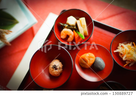 Red tableware and Japanese food presentation 130889727