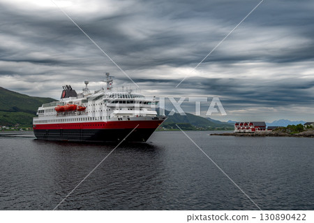 Big Cruise Ship And Ferry Arrives In The Harbor Of Stokmarknes At The Lofoten In Norway Big Cruise Ship And Ferry Arrives In The Harbor Of Stokmarknes At The Lofoten In Norway 130890422