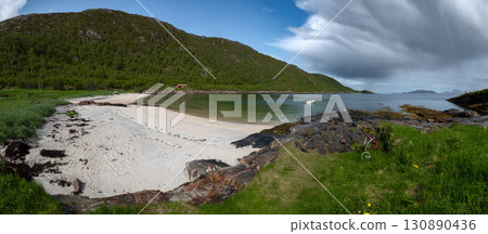 White Sand Beach With Red Cottage And Calm Fjord On Sommaroy Island In Norway White Sand Beach With Red Cottage And Calm Fjord On Sommaroy Island In Norway 130890436