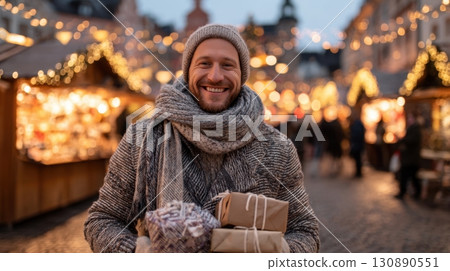 Happy Man Smiling in Winter Clothes at Christmas Market with Gifts Happy Man Smiling in Winter Clothes at Christmas Market with Gifts 130890551