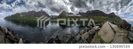 Calm Fjord With Red Huts In Front Of Snowy Mountains On Senja Island In Norway Calm Fjord With Red Huts In Front Of Snowy Mountains On Senja Island In Norway 130890589