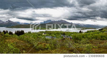 Red Hut Cottage In The Mountains With View To Fjord On Andoya Island At The Vesteralen In Norway Red Hut Cottage In The Mountains With View To Fjord On Andoya Island At The Vesteralen In Norway 130890608