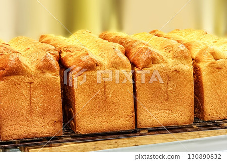 Healthy bread. Golden-brown loaves, freshly baked, their crusty exterior hints at a soft, warm interior, inviting passersby to savor simple, comforting joy of street-baked bread. Bakery shop concept Healthy bread. Golden-brown loaves, freshly baked, their crusty exterior hints at a soft, warm interior, inviting passersby to savor simple, comforting joy of street-baked bread. Bakery shop concept 130890832