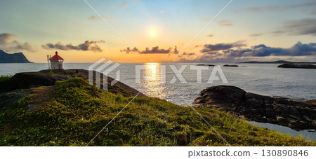Hamn Lighthouse At Fjord Coast With Midnight Sun On Senja Island At Vesteralen In Norway 130890846