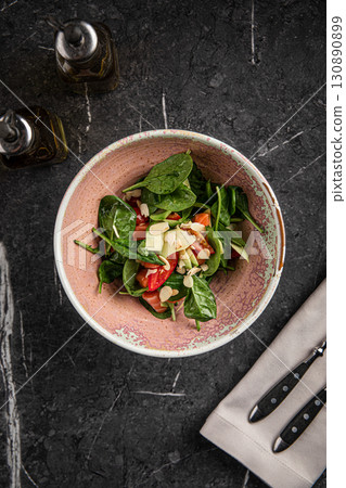 Spinach salad with salmon, almonds and vegetables Spinach salad with salmon, almonds and vegetables 130890899