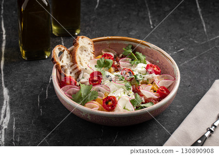 Colorful vegetable salad with radish and tomatoes 130890908