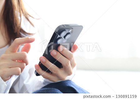 Woman using a smartphone 130891159