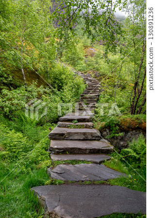 Hiking Path With Devils Stairs To Djevelporten The Devils Stone In Svolvaer On Lofoten Islands In Norway Hiking Path With Devils Stairs To Djevelporten The Devils Stone In Svolvaer On Lofoten Islands In Norway 130891236