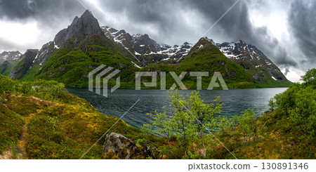 Snowy Mountains And Calm Fjord On Lofoten Islands In Norway 130891346