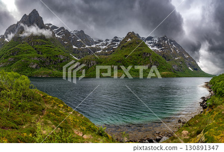 Snowy Mountains And Calm Fjord On Lofoten Islands In Norway 130891347