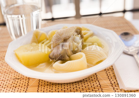 chicken broth soup with chicken, potatoes, and pasta shells chicken broth soup with chicken, potatoes, and pasta shells 130891360