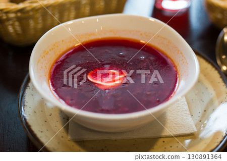 beetroot soup with sour cream in bowl 130891364