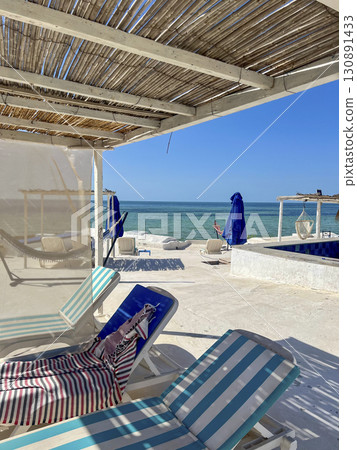 Relaxing day at a beautiful beach in Djerba, Tunisia with turquoise waters and sunny skies 130891433