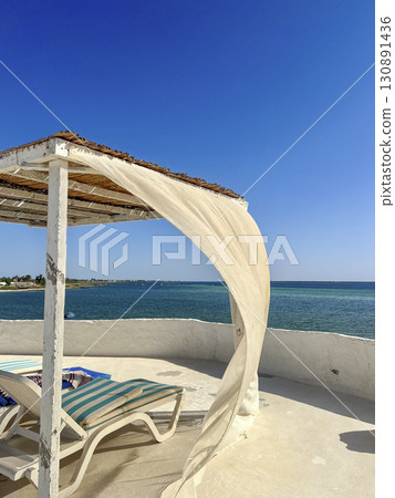 Relaxing day at a beautiful beach in Djerba, Tunisia with turquoise waters and sunny skies 130891436