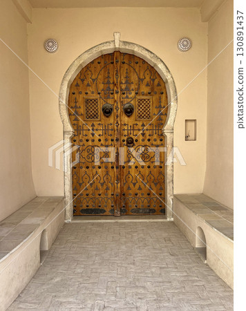 Beautifully crafted wooden door in Djerba Tunisia, showcasing traditional architecture and intricate Beautifully crafted wooden door in Djerba Tunisia, showcasing traditional architecture and intricate 130891437