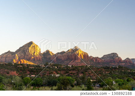 Golden sunset illuminates Sedona red rock formations and scenic desert landscape 130892188