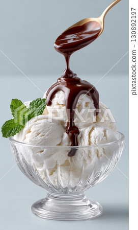 Indulgent dessert featuring vanilla ice cream with chocolate sauce and mint 130892197