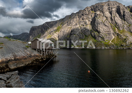 Coastal Hut At A Calm Fjord In Nusfjord On Lofoten Islands In Norway 130892262