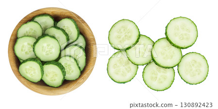 Sliced cucumber in wooden bowl isolated on white background with full depth of field. Top view. Flat lay. 130892423