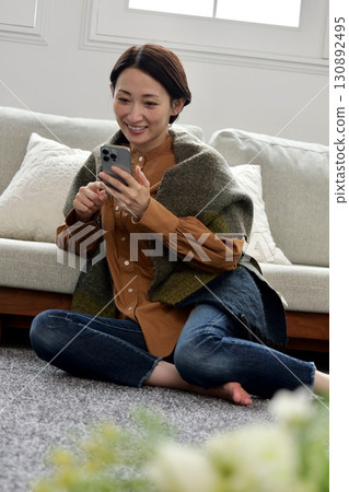Woman operating a mobile phone Woman operating a mobile phone 130892495